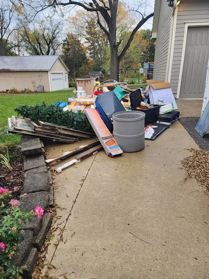 Dumpster being loaded with debris for Estate Cleanout Dumpster Rental in Northborough